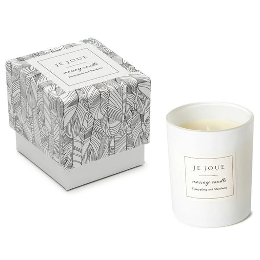 White candle with 'Je Joue' label and patterned box on a white background