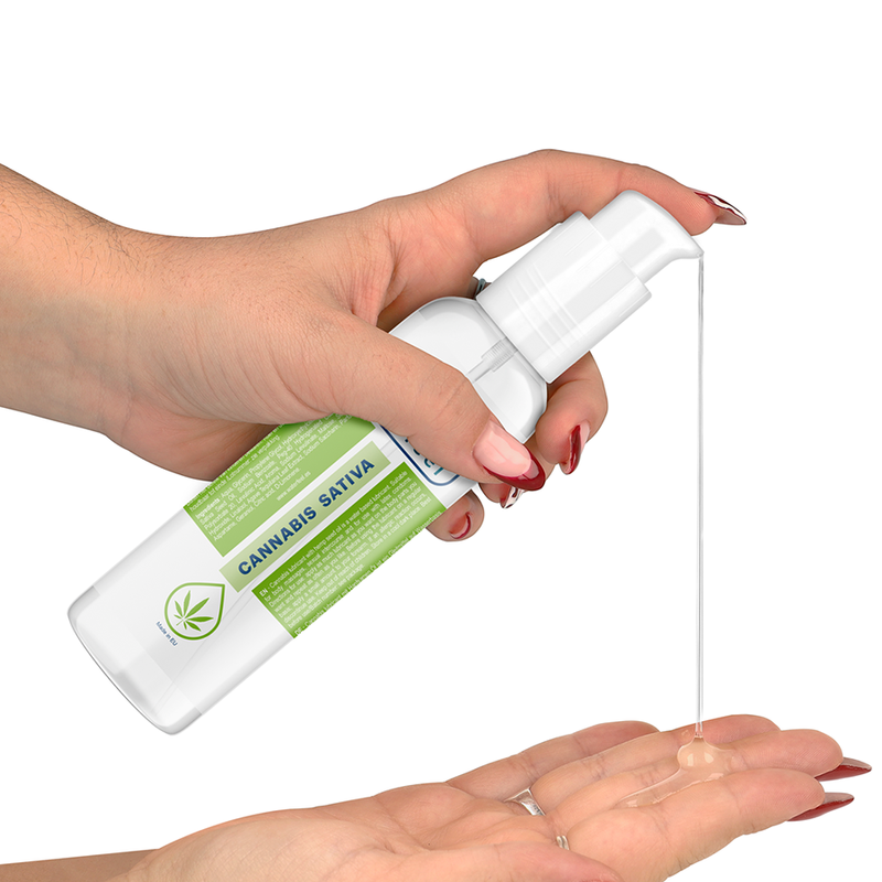 Hand holding a Cannabis Sativa spray bottle with a white background