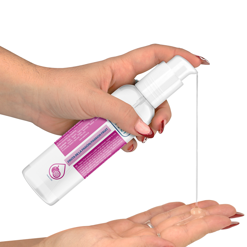 Hand holding a white spray bottle with pink label, dispensing liquid onto another hand against a white background