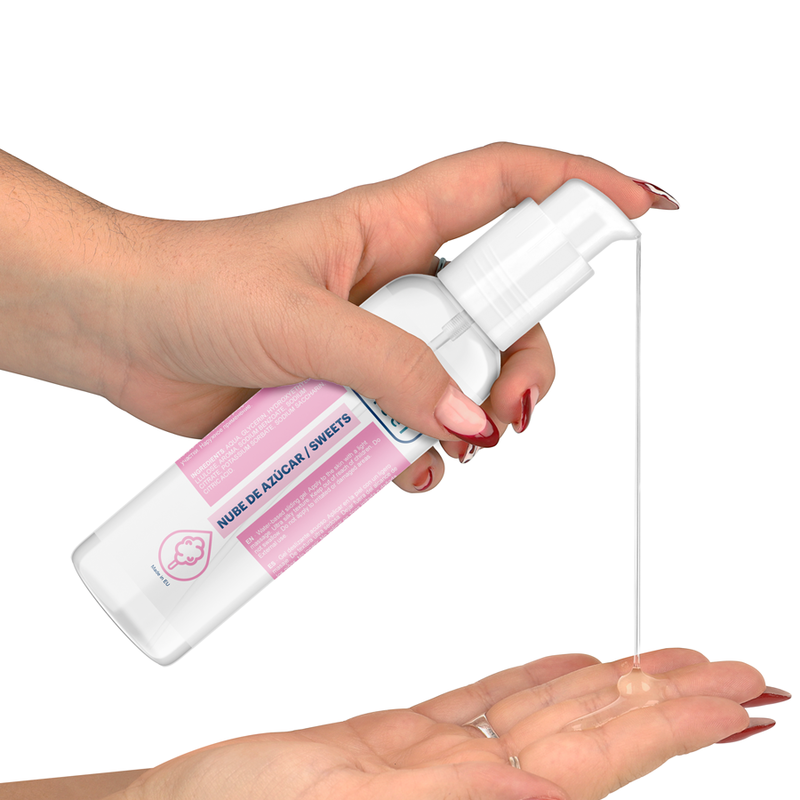 Hand holding a white spray bottle with pink label, dispensing liquid onto another hand against a white background