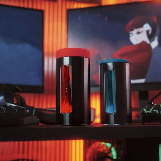 Two cylindrical containers with red and blue lids on a desk with a blurred background