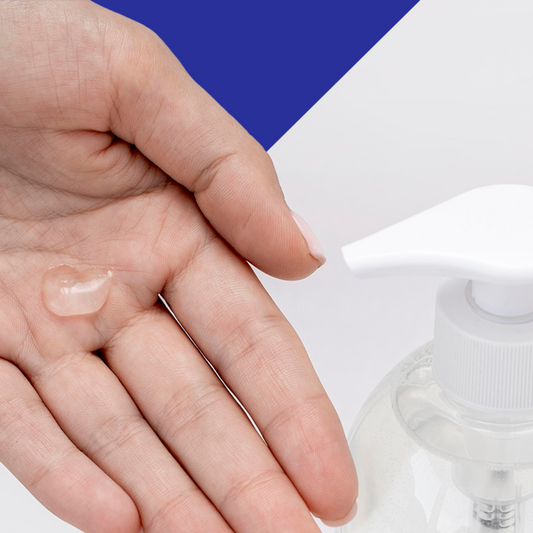 Hand applying clear lotion with a bottle of lotion in the background