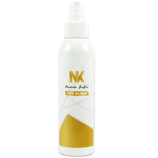 White spray bottle with gold accents and 'NK' branding on a white background