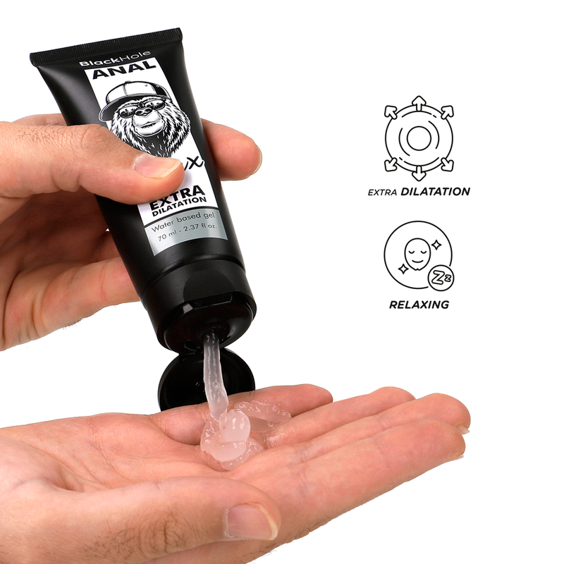 Hand holding a tube of Black Hole Anal Extra Dilatation product with visible lubricant on palm.