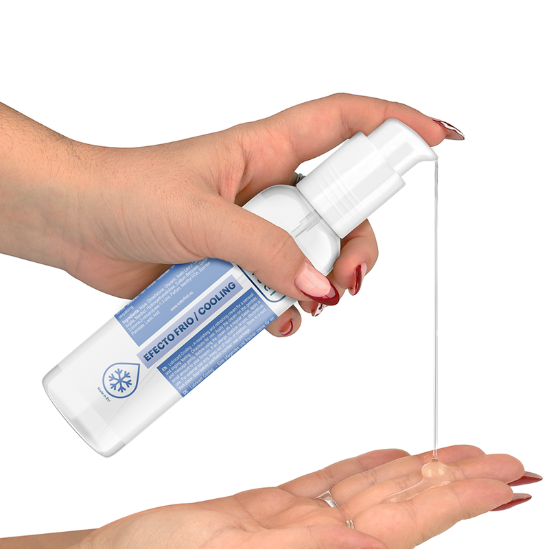 Hand holding a white spray bottle with a blue label, dispensing liquid onto another hand against a white background.