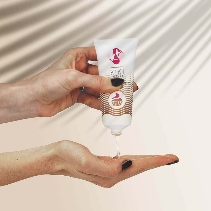 Hand holding a KIKI Cosmetics product with a beige background
