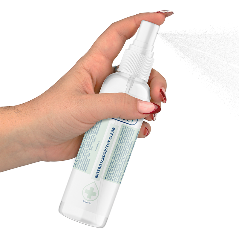 Hand holding a white spray bottle with a label on a white background