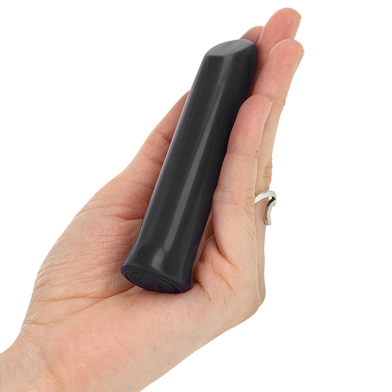 Hand holding a black cylindrical object against a white background