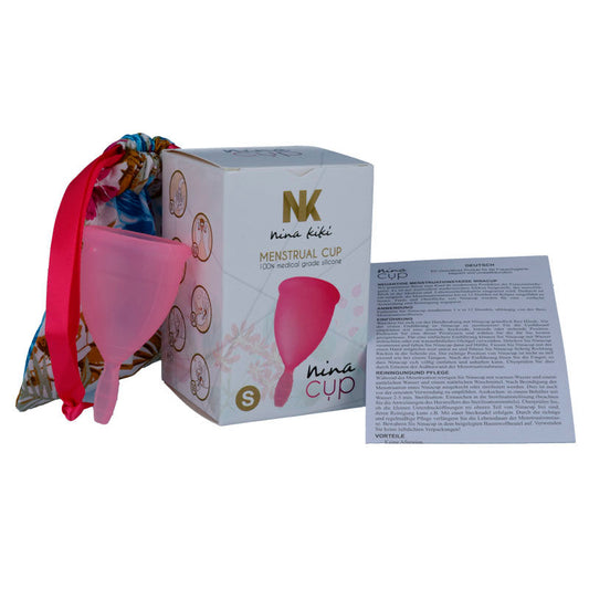 Pink menstrual cup with Nina Cup packaging and instructions on a white background